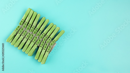 Top view clothes-pins on blue background