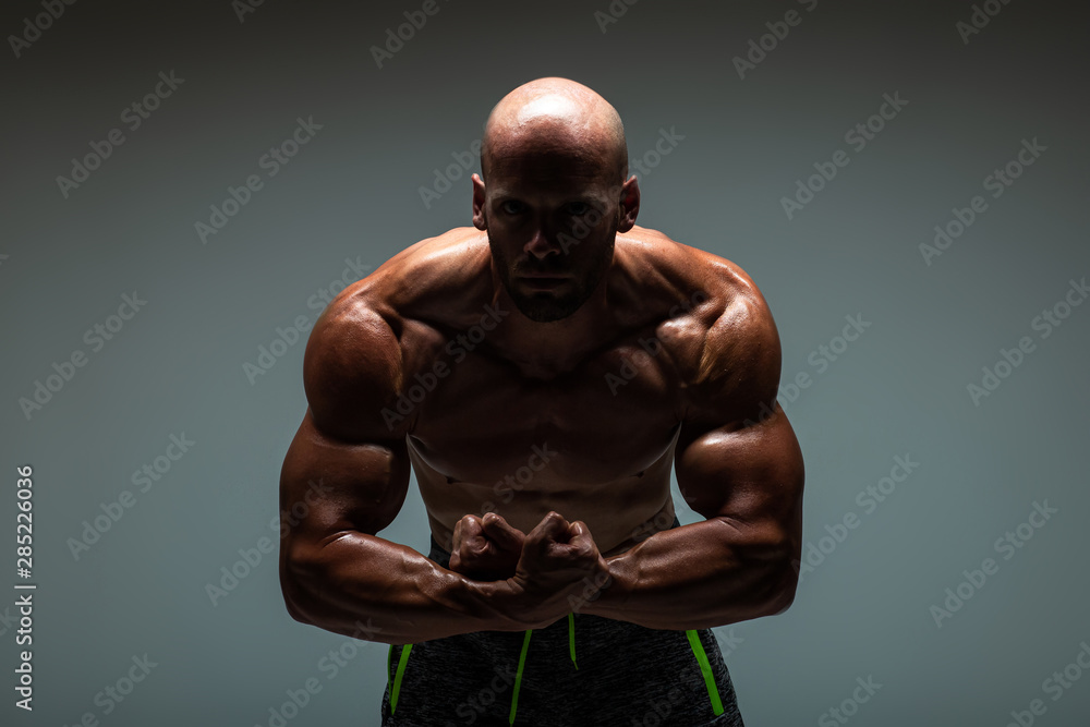 Fototapeta premium Brutal strong athletic bodybuilding men posing in studio. Bodybuilding and healty life concept. 
