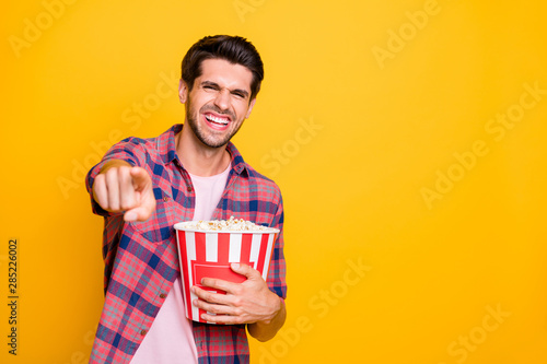 Photo of cheerful laughing rejoicing guy watching comedy movie with friends while isolated with yellow background