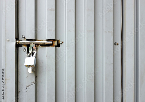 Close up key locked at metal door. © zilvergolf