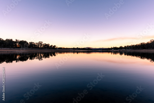 Reflection during winter sunset over dam on a clear day in Storm King, Queensland, Australia