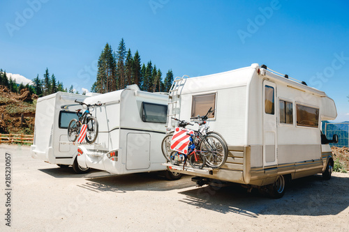 House camper on the wheels, travel in vacation. Camper with bicycles on a camping site. caravan car summer holidays by the sea sunny morning