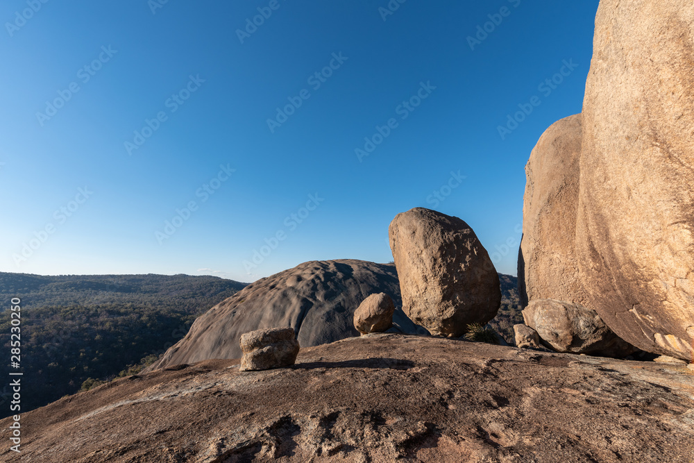Huge boulders balance perfectly on Pyramid Rock on a clear and sunny day in Girraween NP, Queensland, Australia