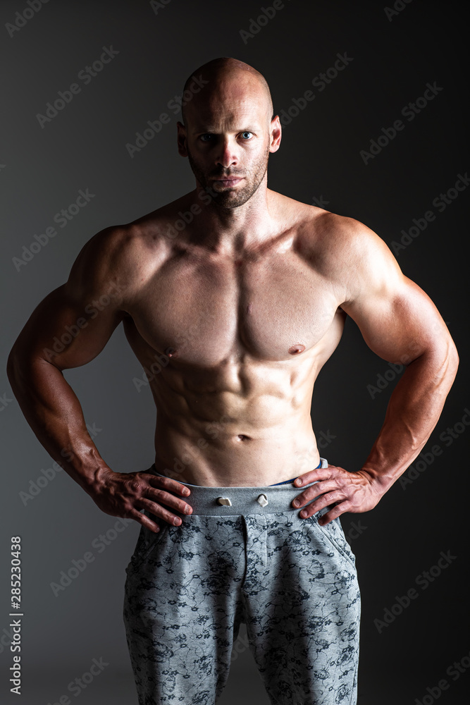 Brutal strong athletic bodybuilding men posing in studio. Bodybuilding and healty life concept. 