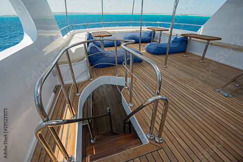 Table and chairs on deck of a luxury motor yacht © Paul Vinten