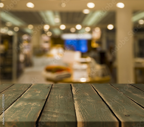 Wooden table with blurred restaurant scene