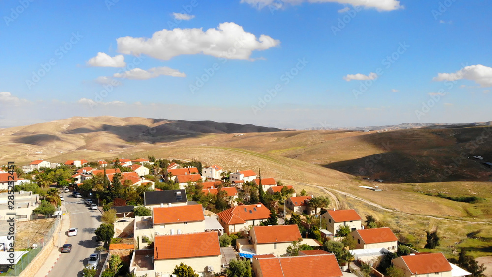 Small town with red rooftops Close to the desert Aerial view Drone shot of Houses Close to the desert in Israel city of Maale adumim