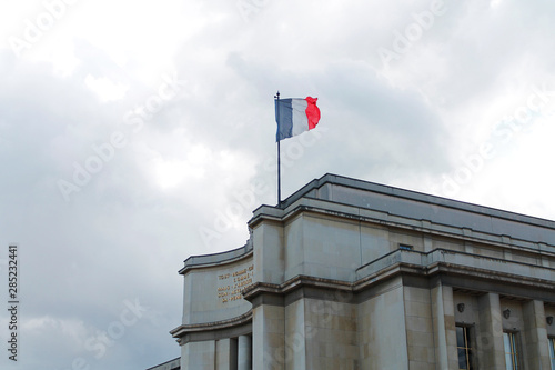 French Flag on building on a gloomy day in Paris