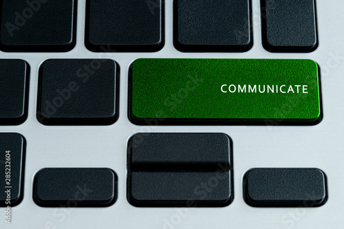 Communicate Text on Laptop Keyboard Green Button. Theme of Social Media and Content Sharing Terms.