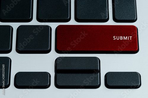 Submit Text on Laptop Keyboard Red Button. Theme of Social Media and Content Sharing Terms. photo