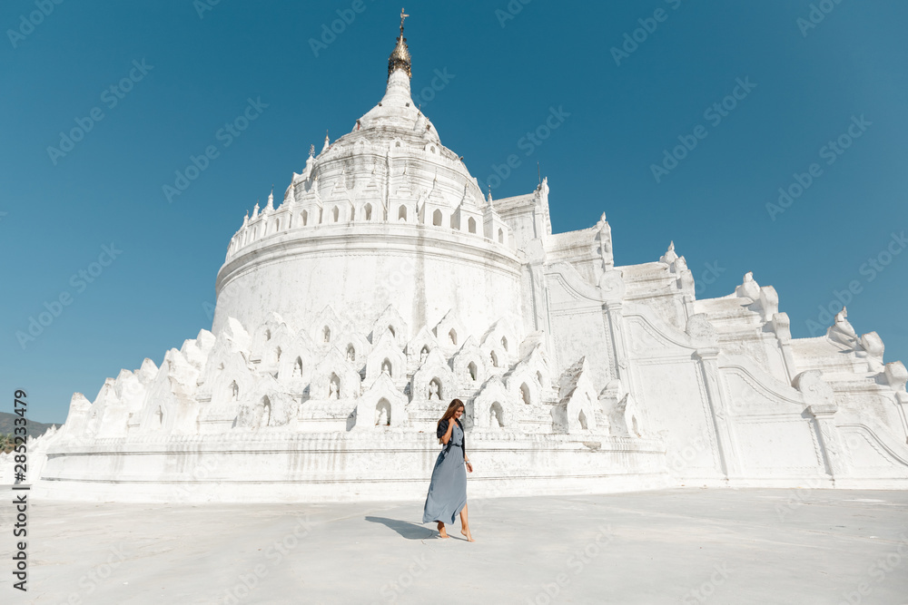 Young  Caucasian woman travller  walking in frot of Hsinbyume Pagoda in Mandalay, Myanmar