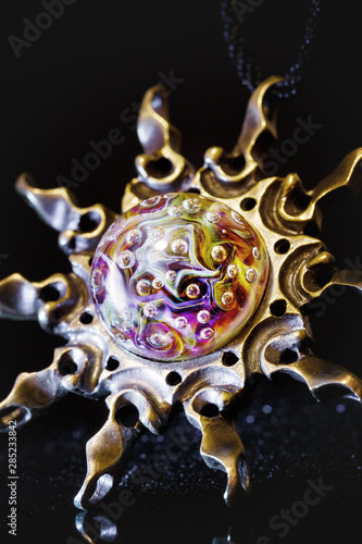 Creative shot of pendant sun made from brass and glass