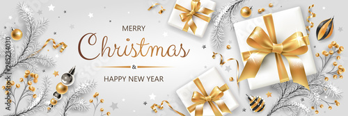 Horizontal banner with gold and silver Christmas symbols and text. Christmas tree, gifts, decoration and other festive elements on white background.