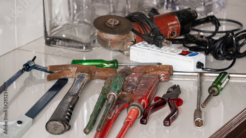 There is a front view of many building tools on the table.