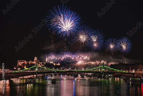 Colorful blue fireworks over Budapest, River Danube with bridges, night