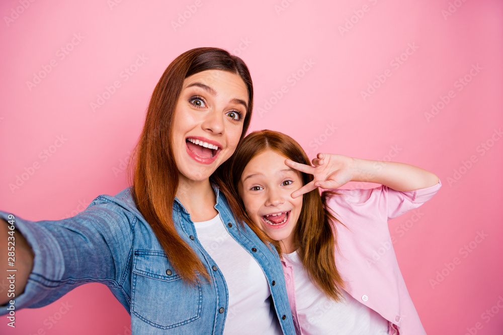 Close up of dreamy small adult people with foxy hairstyle making photo laughing wearing jeans denim shirt isolated over pink background Close up of dreamy small adult people with foxy hairstyle making photo laughing wearing jeans denim shirt isolated over pink background