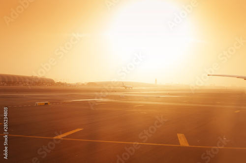 Photography Airplane taxiing on at airport runway in haze