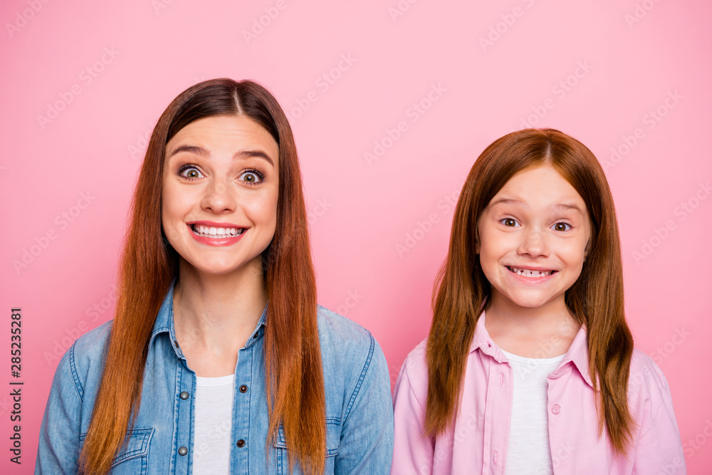 Close up photo of charming girls looking with beaming smile isolated over pink background Close up photo of charming girls looking with beaming smile isolated over pink background