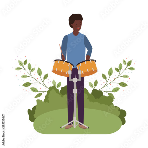 man with timpani and branches and leaves in the background photo