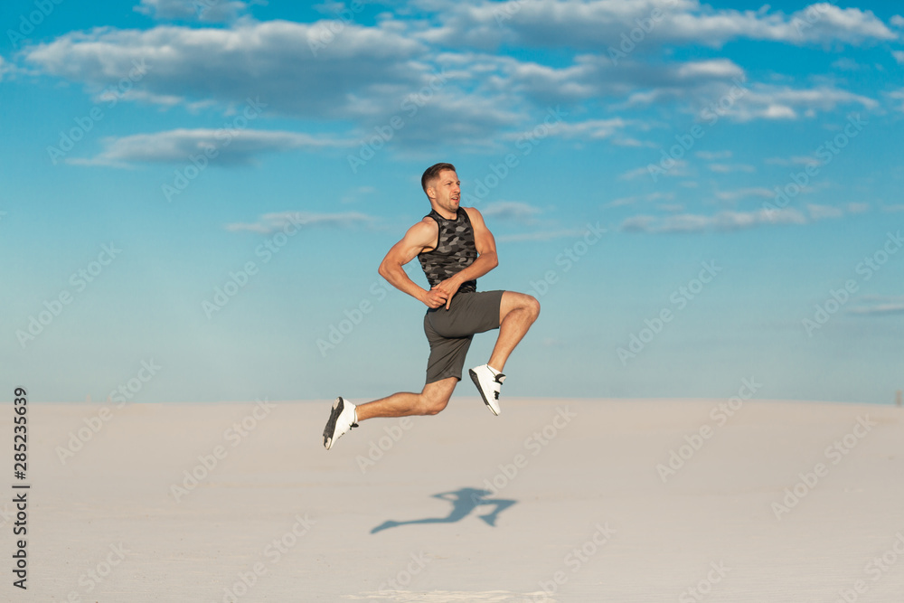 Fitness man doing exercises in sand desert. Sport concept Fitness man doing exercises in sand desert. Sport concept