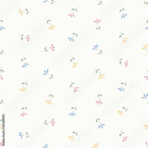 Seamless pattern of small pastel pink, blue and yellow flowers.