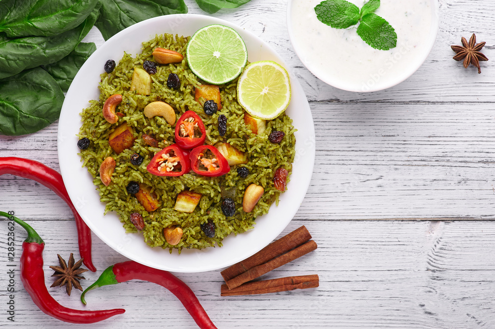 Foto Stock Palak Paneer Biryani and Raita at white wooden background