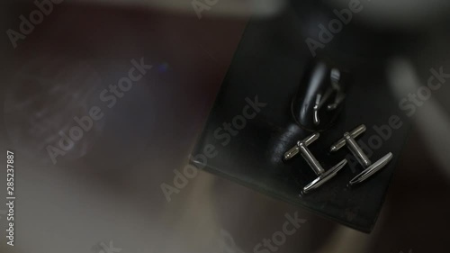 Men's golden cufflinks for a shirton in sunlights light sun glares Macro slider closeup