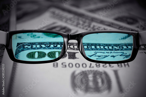 View through glasses of US dollars