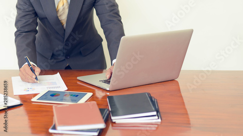 Business man working at desk with laptop and document