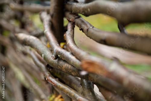 wooden wicker fence of branches made of twigs © goldeneden