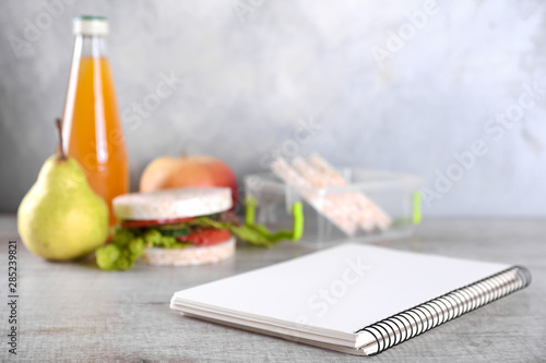 lunch for your child in school  box with a healthy sandwich and fruit salad and apple juice in the bottle for drinking