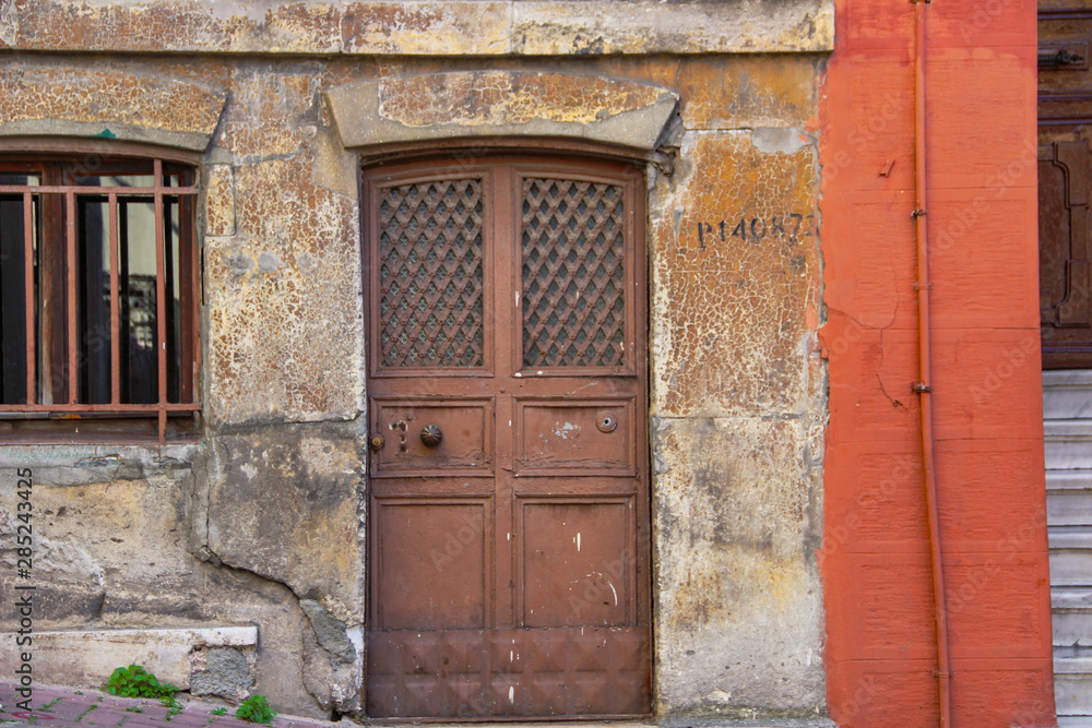 Fototapeta premium Brick stone wall and colorful window in street of Balat in Istanbul