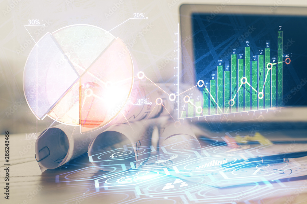 Financial chart drawing and table with computer on background. Multi exposure. Concept of international markets. Financial chart drawing and table with computer on background. Multi exposure. Concept of international markets.