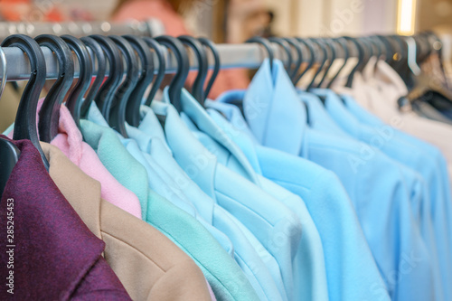 colorful coats hanging on hangers in the store