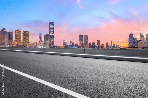 Shanghai skyline and modern buildings with empty asphalt highway at sunrise,China © ABCDstock