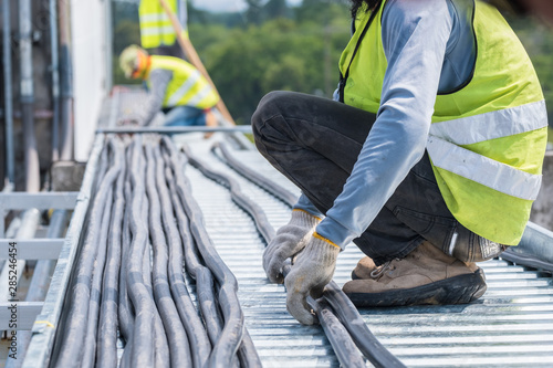 Workers are moving cables in construction sites.