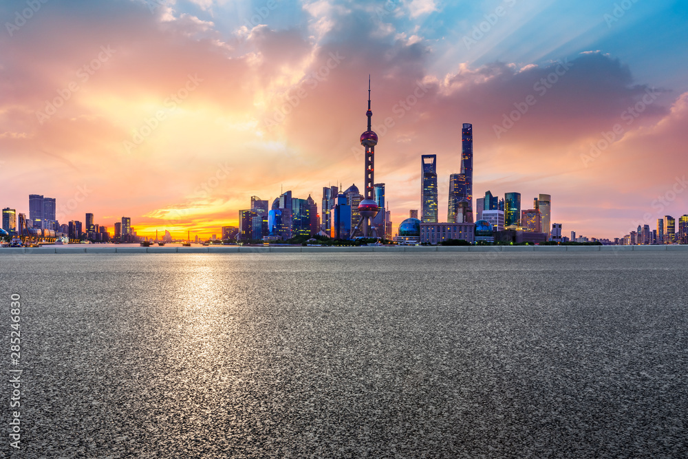 Shanghai skyline and modern buildings with empty asphalt highway at sunrise,China