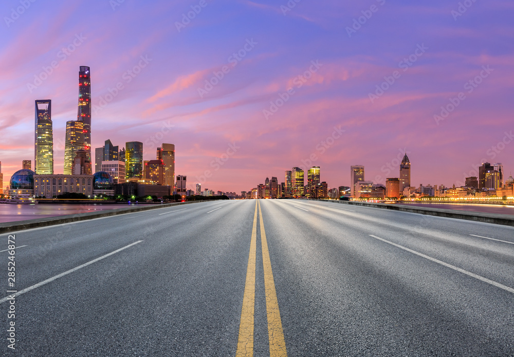 Shanghai skyline and modern buildings with empty asphalt highway at sunrise,China
