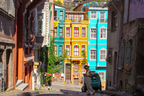 woman and colorful old buildings in Balat in Istanbul
