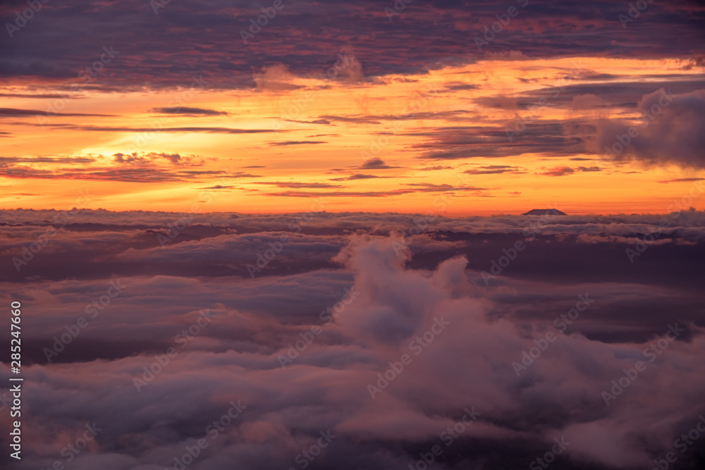 Foggy autumn landscape. Colorful fog and mountains on morning sky background. sunrise