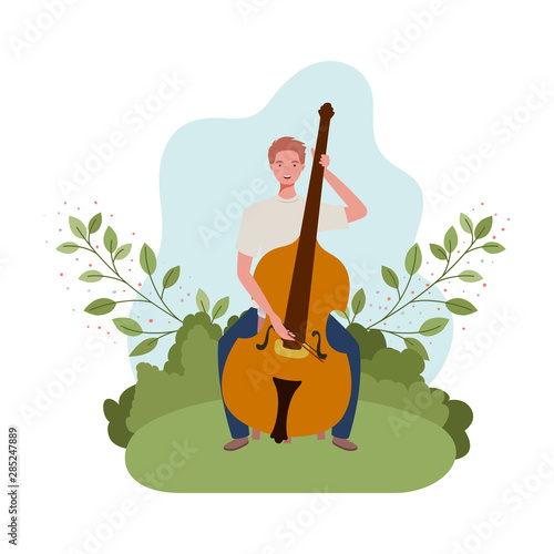 man with fiddle and branches and leaves in the background photo