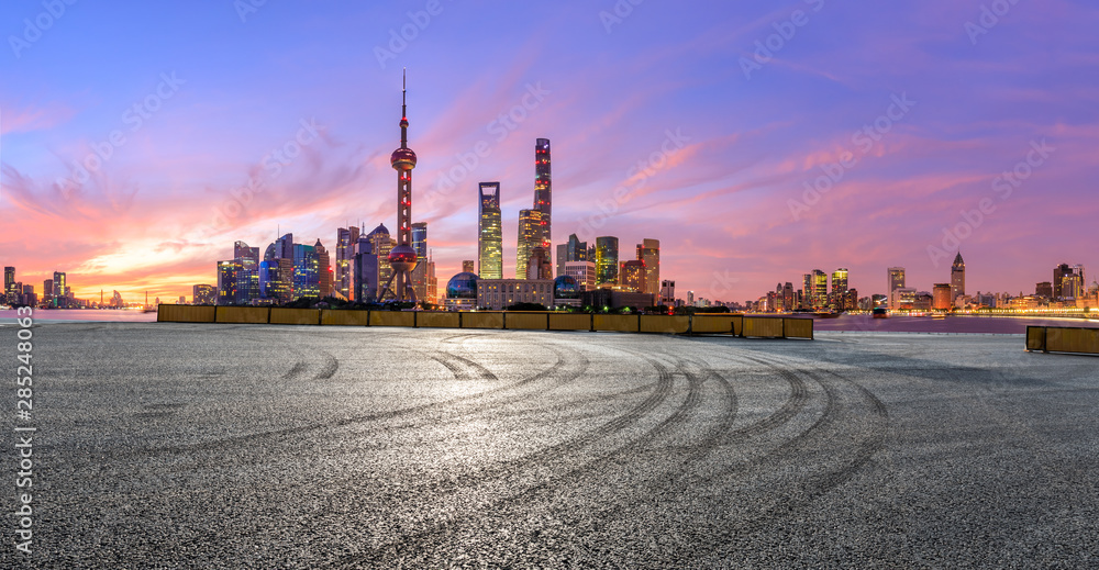 Shanghai skyline and modern buildings with empty race track at sunrise,panoramic view.