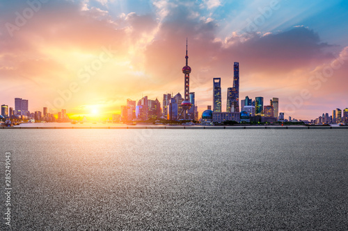 Shanghai skyline and modern buildings with empty asphalt road at sunrise China