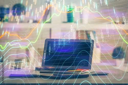 Forex market graph hologram and personal computer on background. Double exposure. Concept of investment.