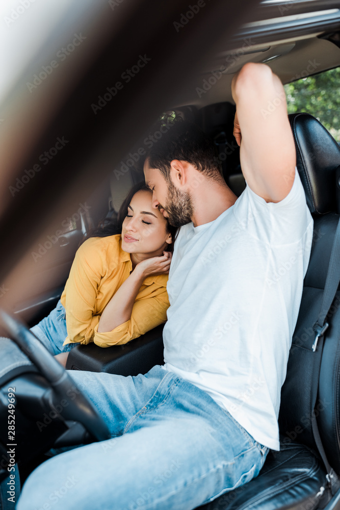 selective focus of young woman sitting near bearded man in car selective focus of young woman sitting near bearded man in car