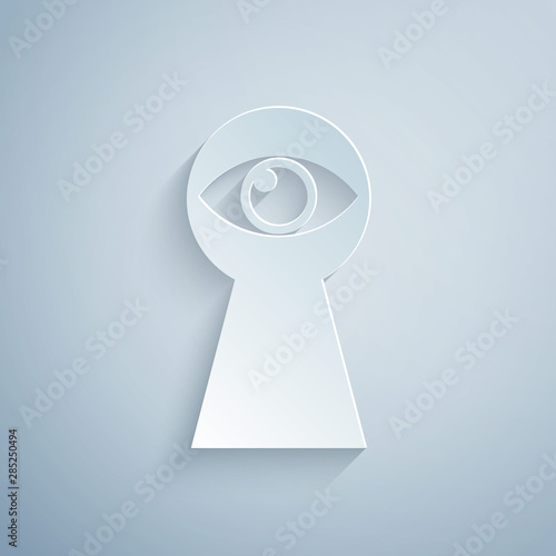 Paper cut Keyhole with eye icon isolated on grey background. The eye looks into the keyhole. Keyhole eye hole. Paper art style. Vector Illustration