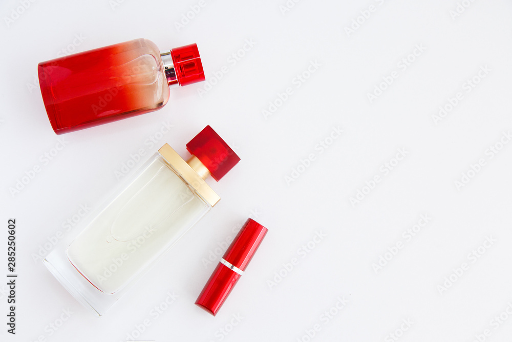 Cosmetics. Women's secrets. Deodorant, lipstick, eau de toilette, perfume. Red bottles with aromatic liquids Cosmetics. Women's secrets. Deodorant, lipstick, eau de toilette, perfume. Red bottles with aromatic liquids
