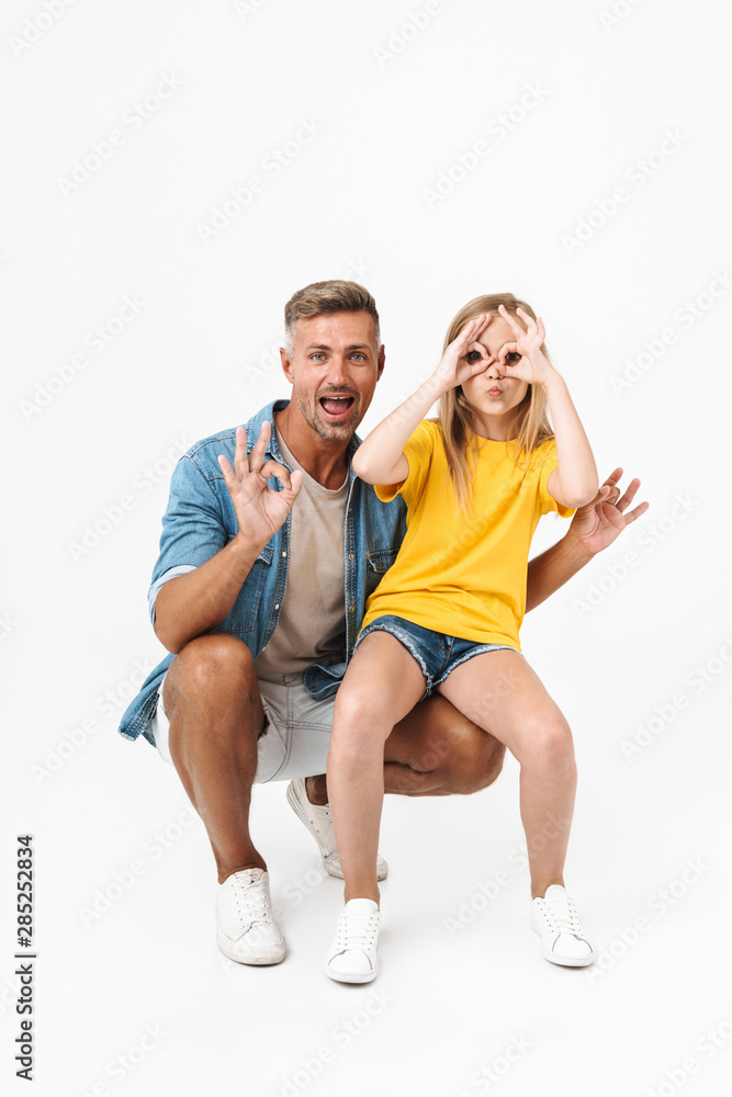 Full length photo of funny caucasian family father and daughter smiling and showing ok sign Full length photo of funny caucasian family father and daughter smiling and showing ok sign