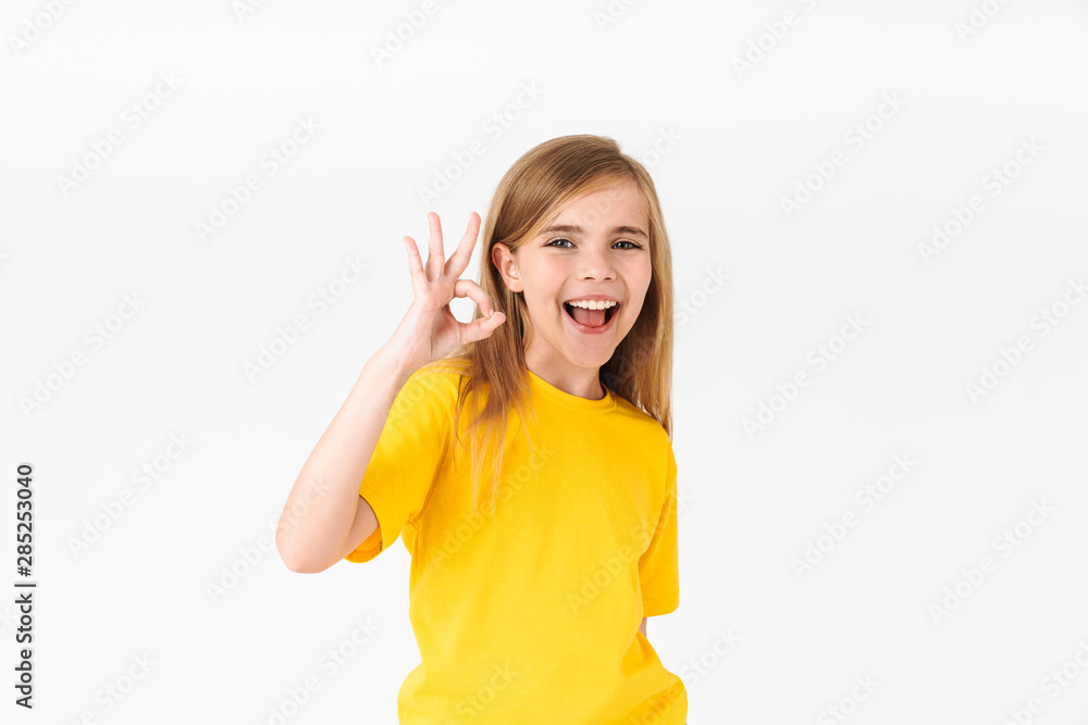 Portrait of happy blonde summer girl wearing casual t-shirt smiling and showing ok sign Portrait of happy blonde summer girl wearing casual t-shirt smiling and showing ok sign