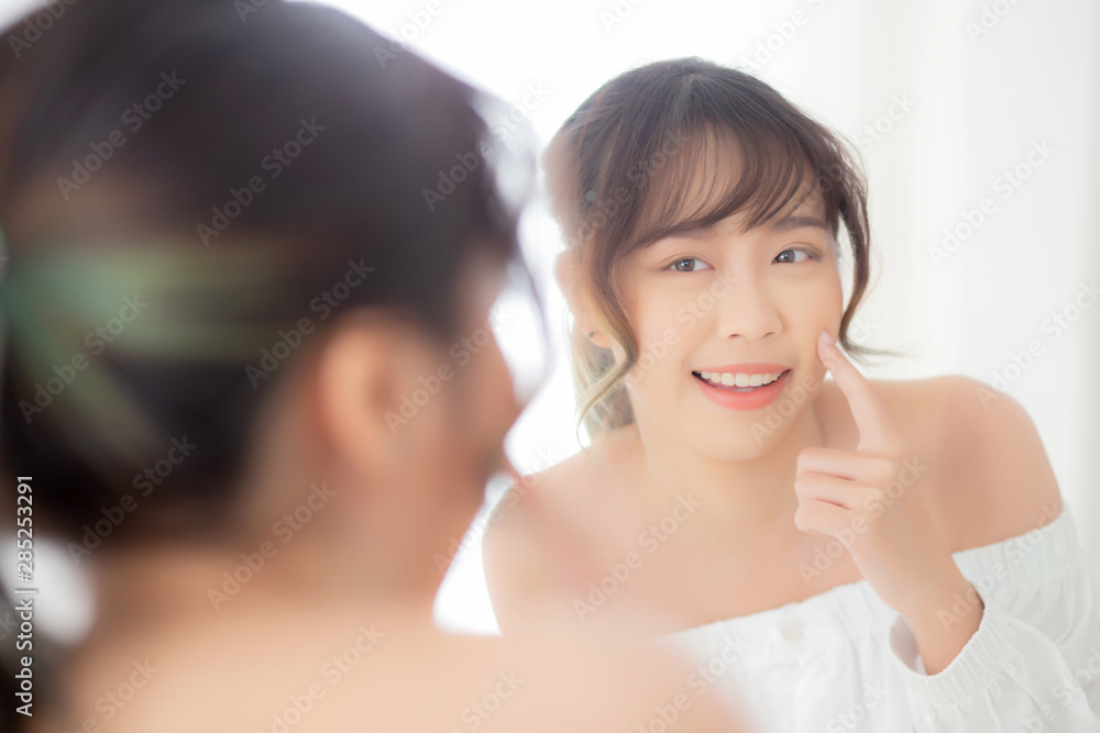 Beautiful face young asian woman with happy smiling and looking mirror, makeup of beauty facial girl with skincare and cosmetic treatment, refresh of female and clean for charming, healthy concept. Beautiful face young asian woman with happy smiling and looking mirror, makeup of beauty facial girl with skincare and cosmetic treatment, refresh of female and clean for charming, healthy concept.